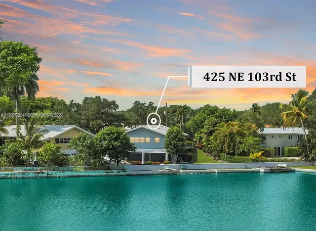a view of swimming pool with lawn chairs and potted plants