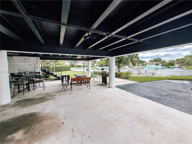 a view of kitchen with granite countertop window and refrigerator