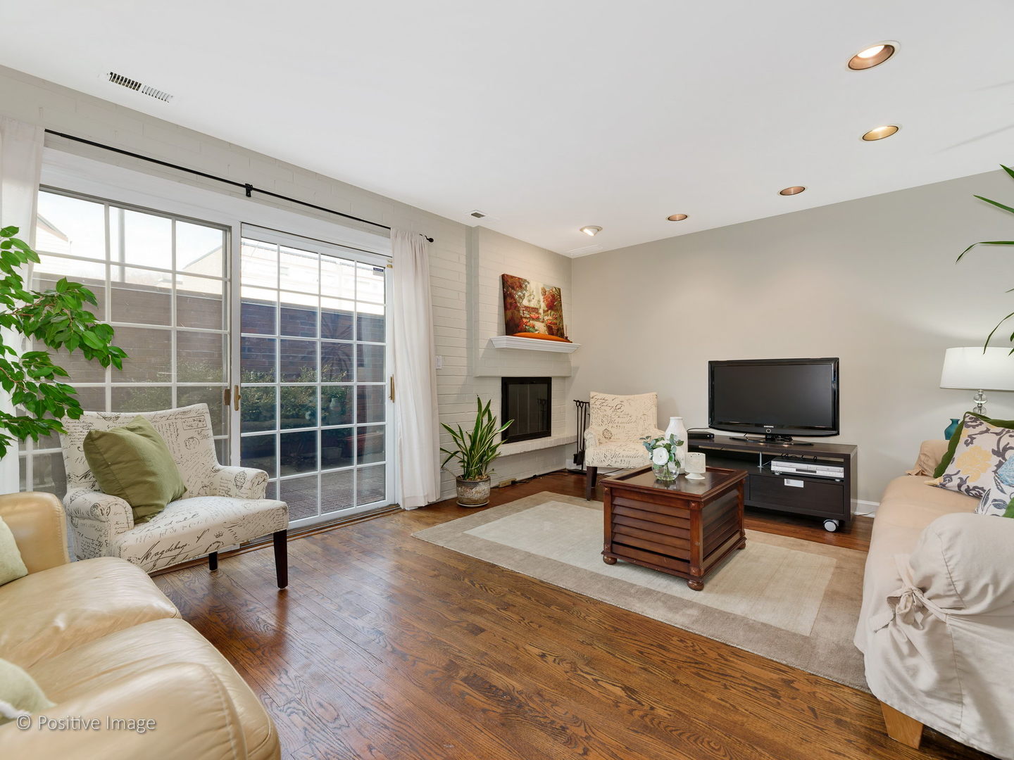 1920 North Mohawk Street, Unit 17 Chicago, IL 60614 - Photo 2 of 28 a living room with furniture a fireplace and a flat screen tv