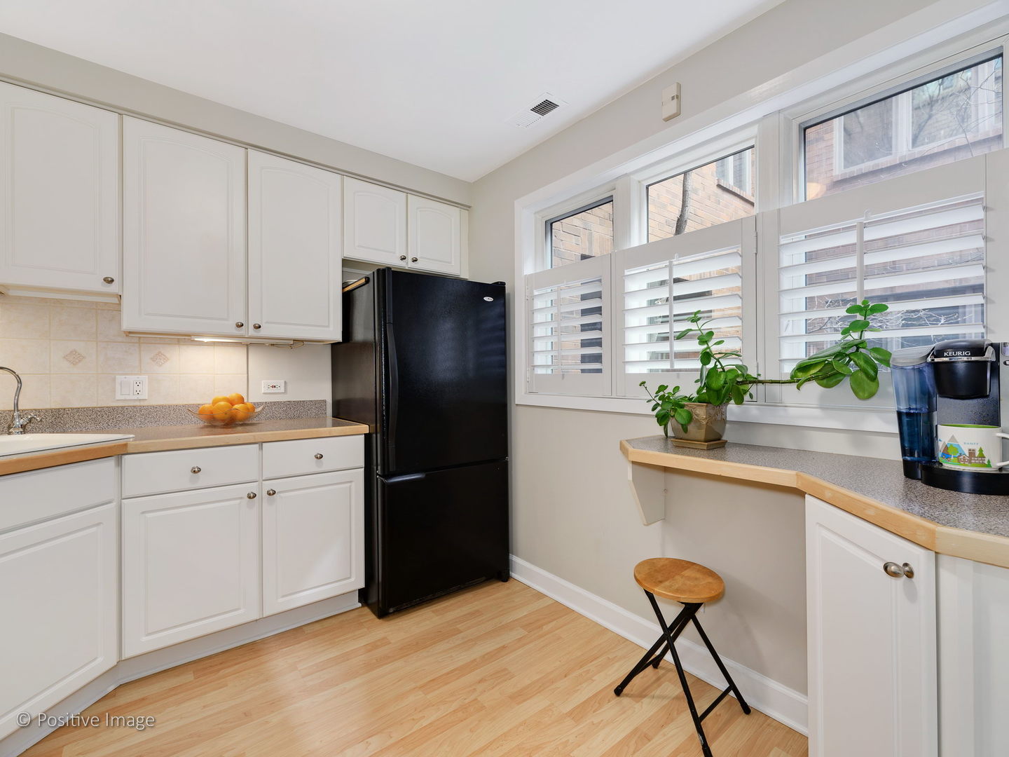 1920 North Mohawk Street, Unit 17 Chicago, IL 60614 - Photo 11 of 28 a kitchen with a refrigerator and a white cabinets