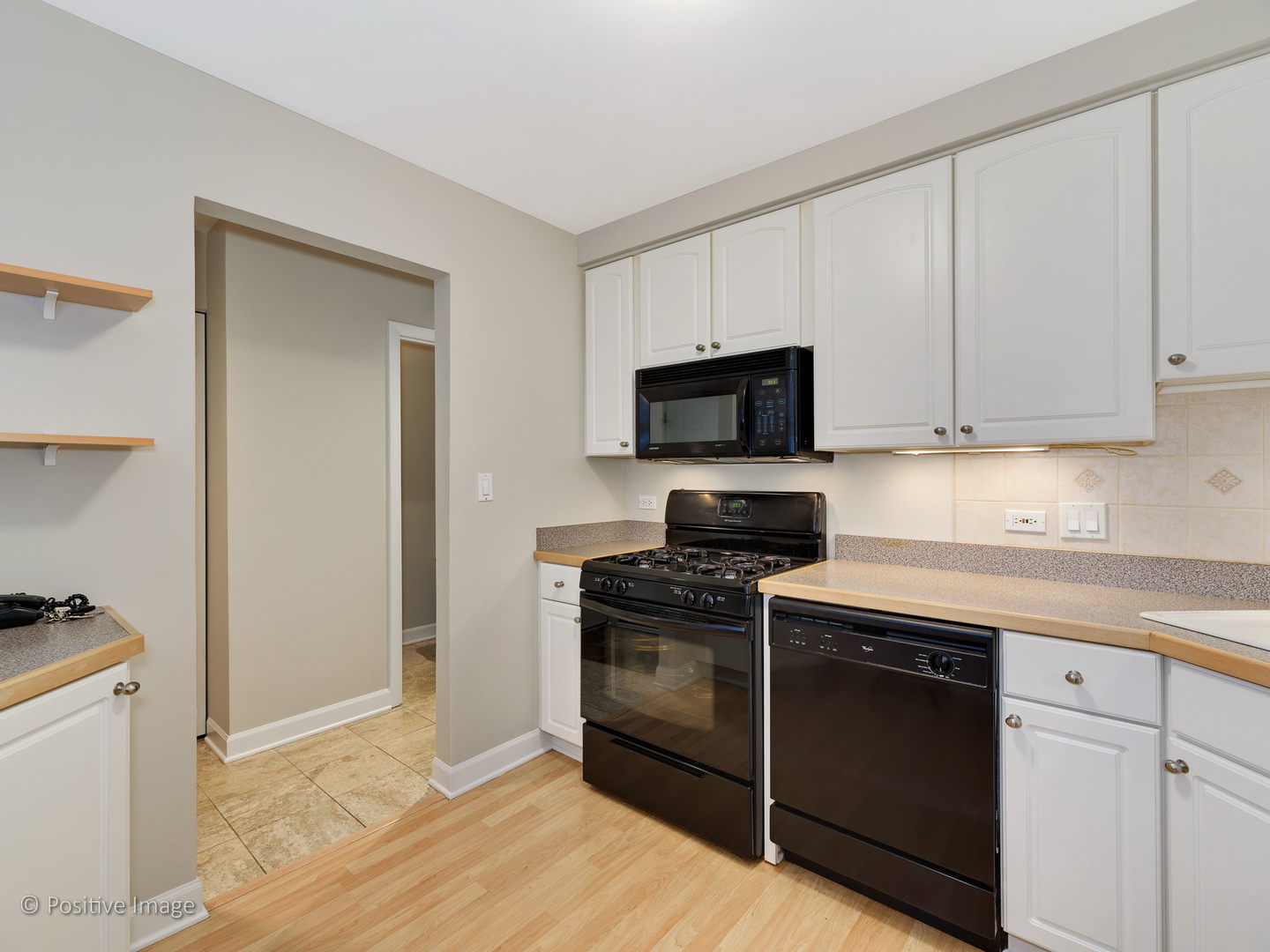 1920 North Mohawk Street, Unit 17 Chicago, IL 60614 - Photo 12 of 28 a kitchen with cabinets stainless steel appliances and wooden floor