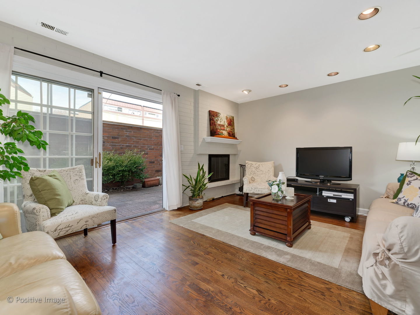 1920 North Mohawk Street, Unit 17 Chicago, IL 60614 - Photo 3 of 28 a living room with furniture a flat screen tv and a fireplace