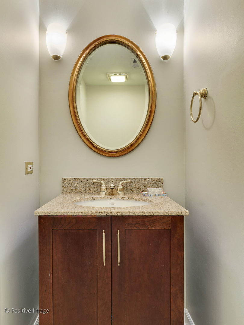 1920 North Mohawk Street, Unit 17 Chicago, IL 60614 - Photo 22 of 28 a bathroom with a sink and a mirror