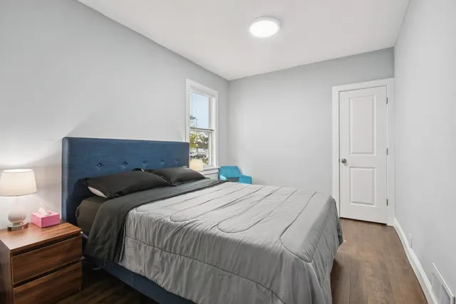 a bedroom with a bed and a lamp