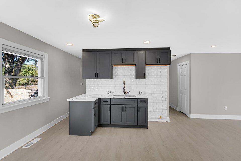 730 Clinton Street Gary, IN 46406 - Photo 3 of 17 a kitchen with stainless steel appliances a sink stove and refrigerator