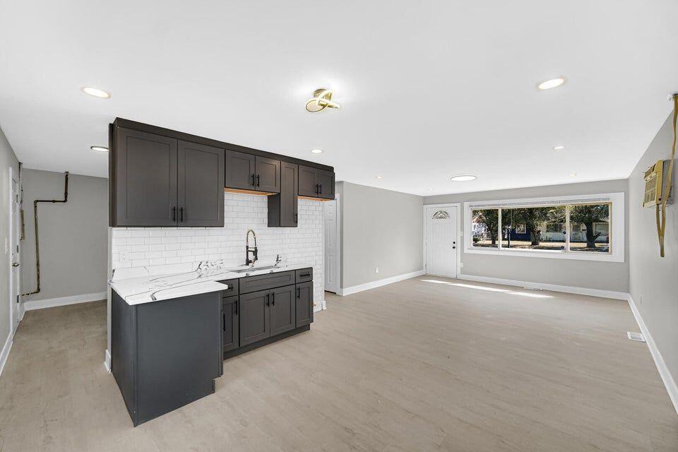 730 Clinton Street Gary, IN 46406 - Photo 4 of 17 a kitchen with granite countertop a stove and a refrigerator