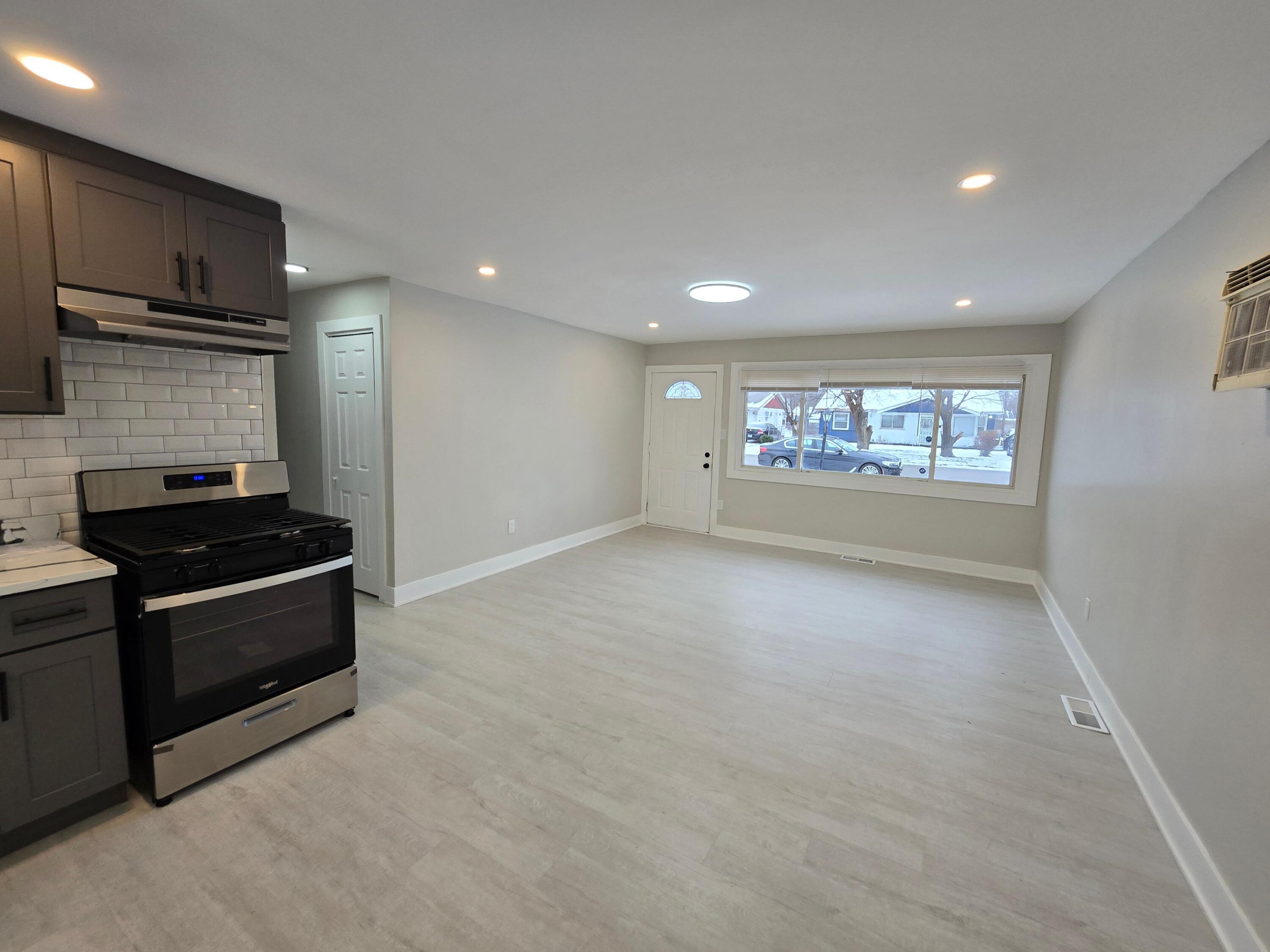 730 Clinton Street Gary, IN 46406 - Photo 7 of 17 a view of an empty room with a stove and a window