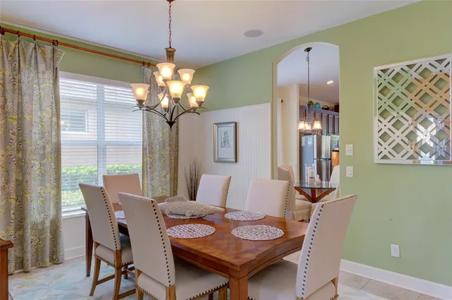 a living room with kitchen island dining table and stainless steel appliances
