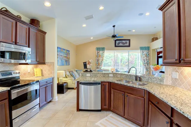 a white refrigerator freezer and a stove sitting inside of a kitchen