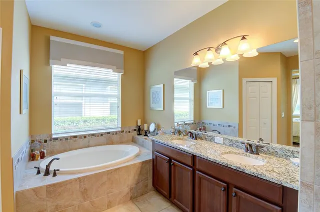 a bathroom with a granite countertop shower mirror and a sink