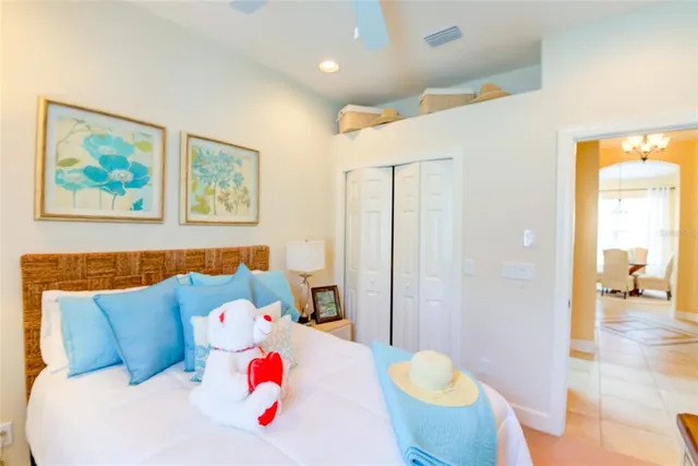 a bedroom with a bed and a chandelier