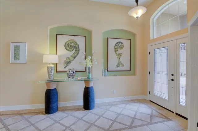 a view of a dining room with furniture and a chandelier