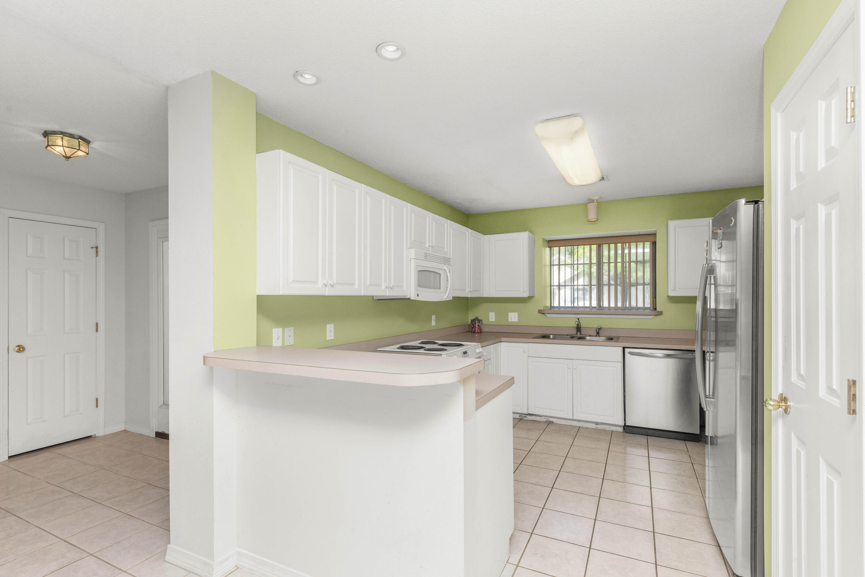 3872 Mesa Road Destin, FL 32541 - Photo 8 of 29 a kitchen with a stove a sink and a refrigerator