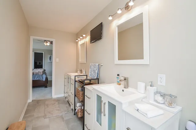 a bathroom with a sink vanity and a mirror