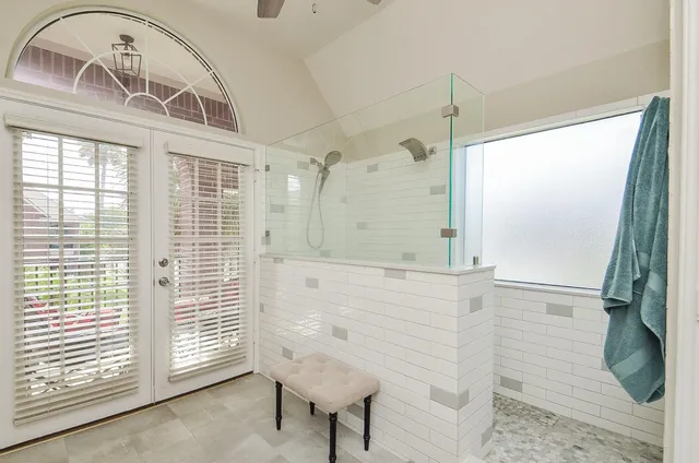 a bathroom with a balcony a sink and a mirror