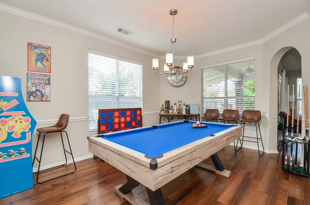 a room with furniture pool table and windows