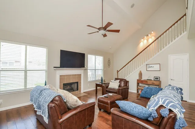 a living room with furniture fireplace and flat screen tv