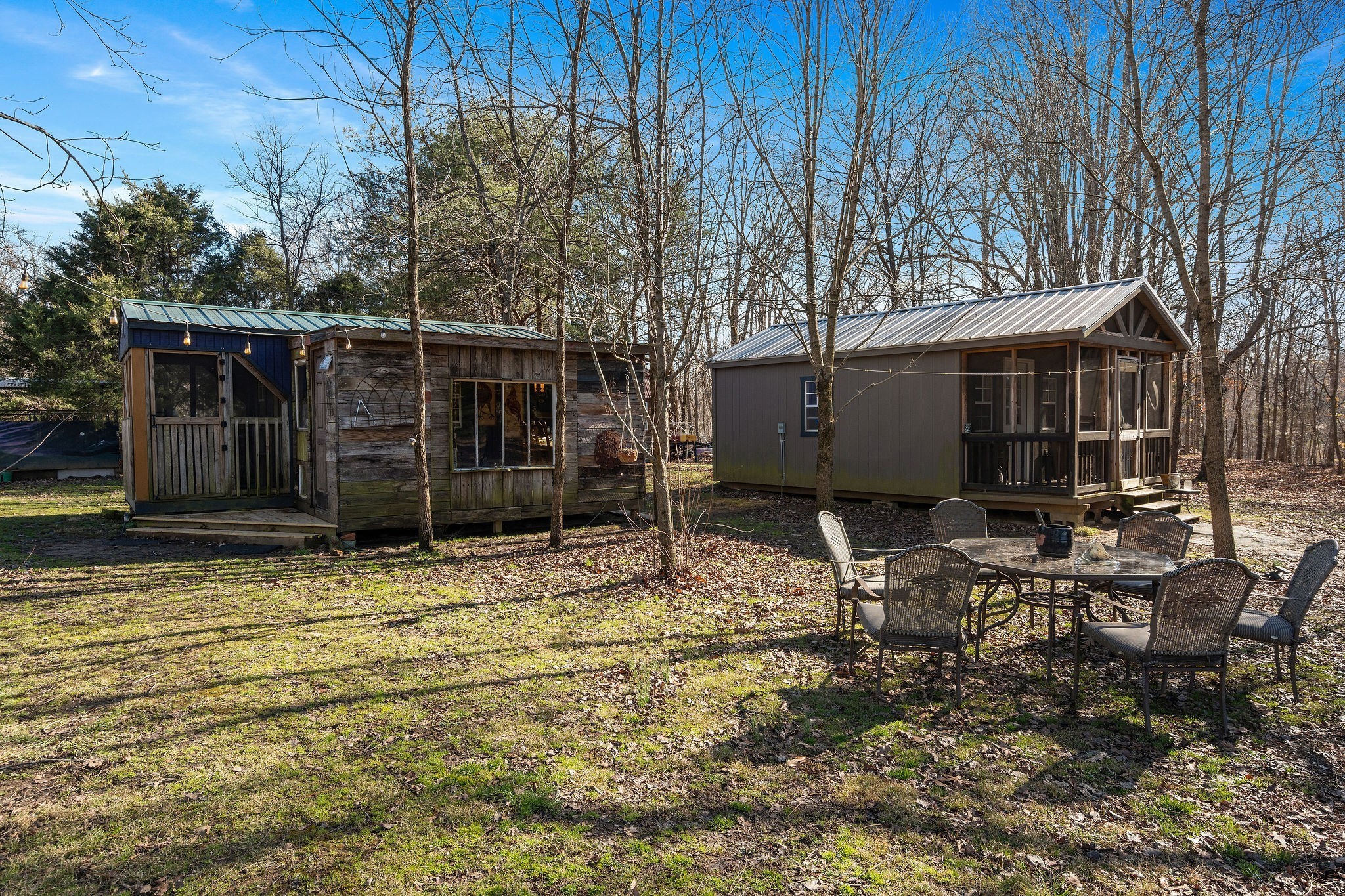 7139 Kingston Road Fairview, TN 37062 - Photo 19 of 48 a view of a backyard with table and chairs and wooden fence