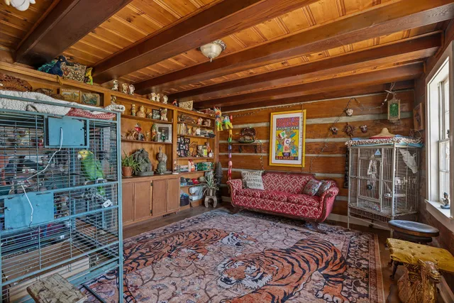 a view of a hallway with wooden floor and furniture