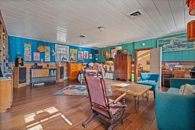 a living room filled with furniture hardwood floor and a table