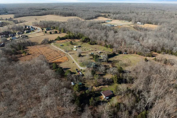 an aerial view of a houses with trees