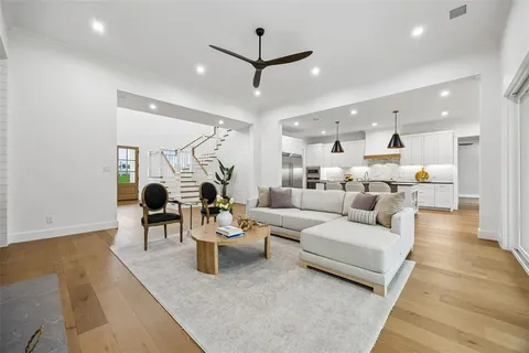 a living room with furniture a table and a potted plant