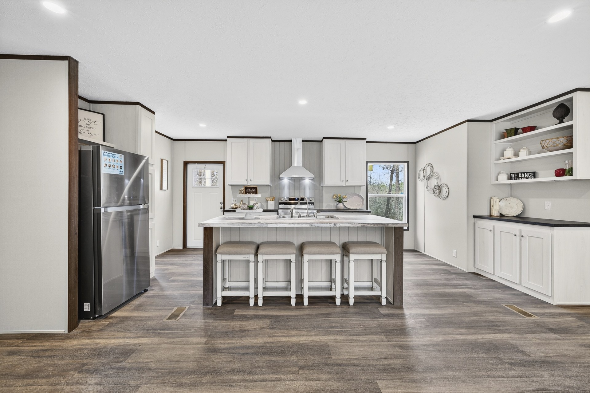 3615 Guys Chewalla Road Ramer, TN 38367 - Photo 14 of 65 a kitchen with stainless steel appliances a dining table chairs refrigerator and sink