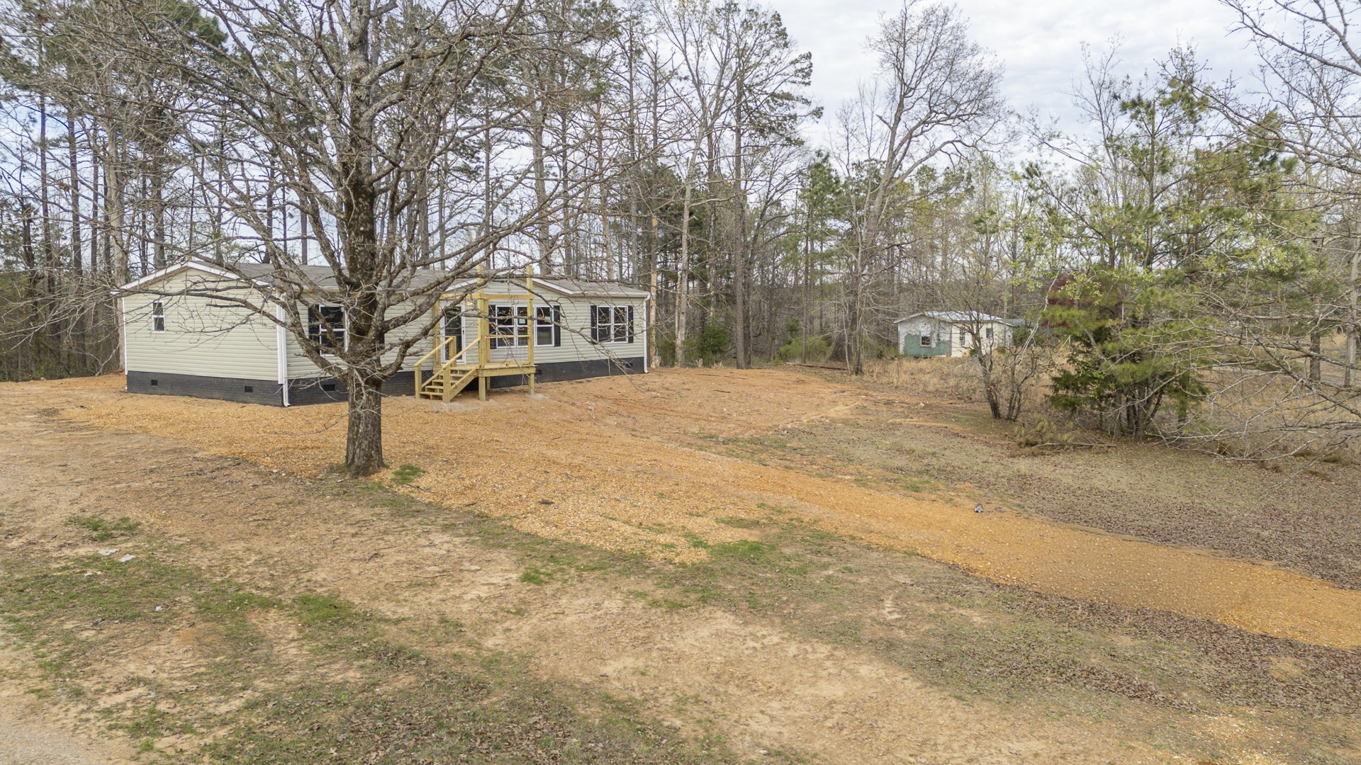 3615 Guys Chewalla Road Ramer, TN 38367 - Photo 59 of 65 a front view of a house with a yard covered in snow