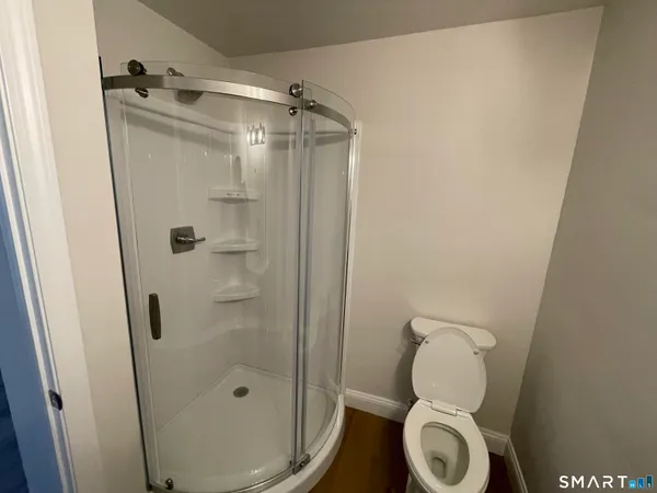 a bathroom with a toilet and a shower