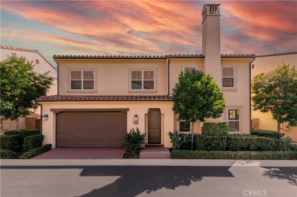 a front view of a house with a garden and plants