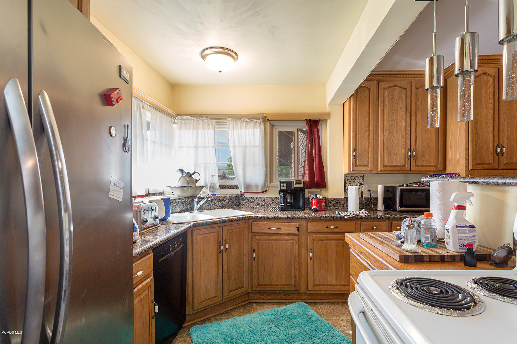 2330 Fitzgerald Road Simi Valley, CA 93065 - Photo 22 of 31 a kitchen with a sink a stove and refrigerator