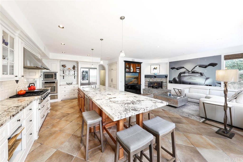 39 Whitehall Newport Beach, CA 92660 - Photo 11 of 35 a large kitchen with a table and chairs