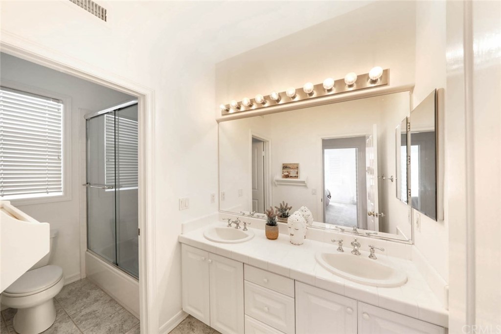 39 Whitehall Newport Beach, CA 92660 - Photo 21 of 35 a bathroom with a sink and a mirror