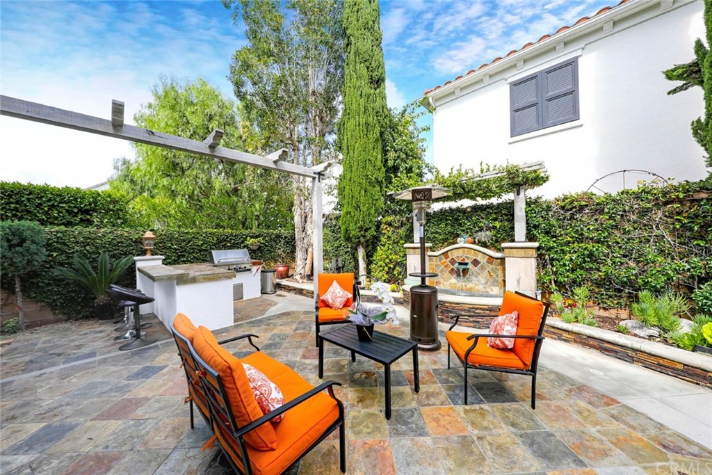 39 Whitehall Newport Beach, CA 92660 - Photo 27 of 35 an outdoor sitting area with a bench and trees