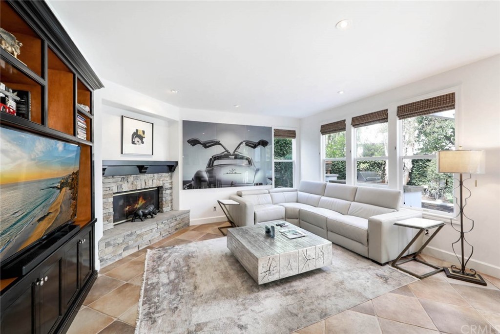 39 Whitehall Newport Beach, CA 92660 - Photo 6 of 35 a living room with furniture large window and a fireplace