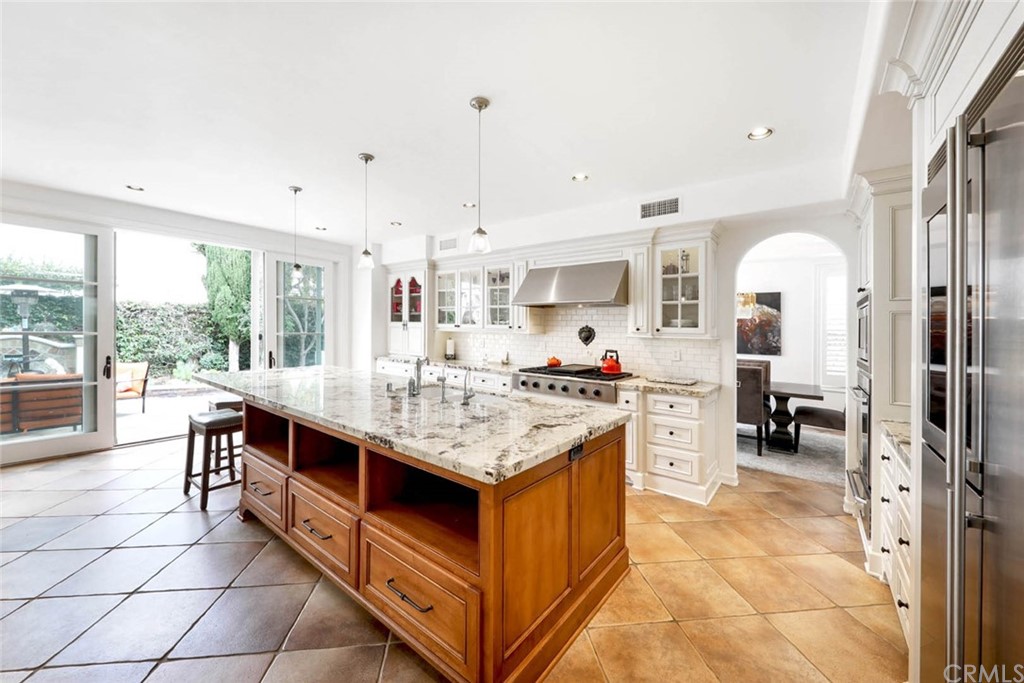 39 Whitehall Newport Beach, CA 92660 - Photo 8 of 35 a kitchen with stainless steel appliances granite countertop a stove and a view of living room
