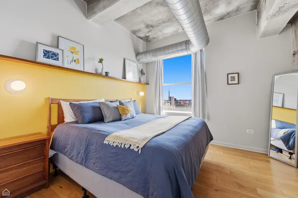a bed sitting in a bedroom next to a tv