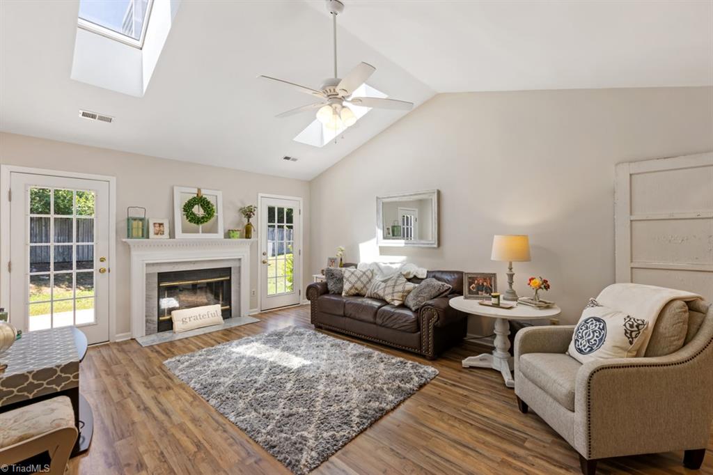 3216 Timberwolf Avenue High Point, NC 27265 - Photo 11 of 20 Living Room has vaulted ceiling, 2 skylights, gas log fireplace, access to deck