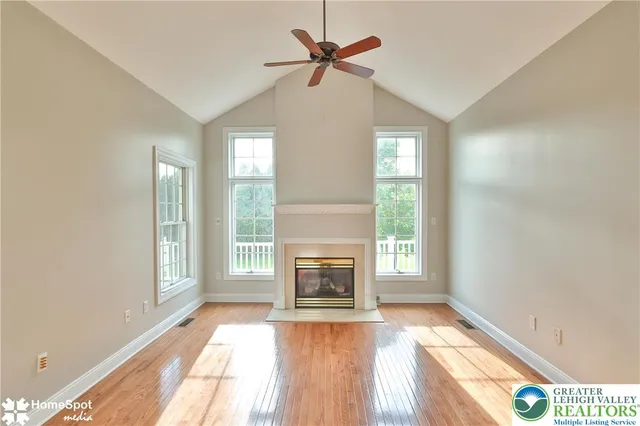 a kitchen with stainless steel appliances kitchen island granite countertop a refrigerator and a sink