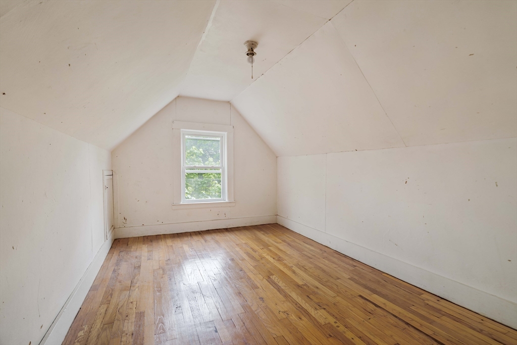 52 Walter Street Boston, MA 02131 - Photo 26 of 31 a view of an empty room with wooden floor and a window