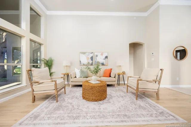 a living room with furniture and a floor to ceiling window