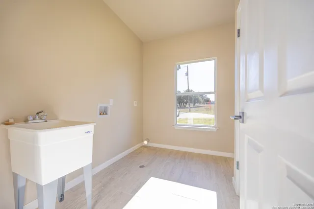 a room with a window and a sink