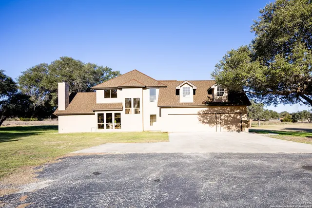 a front view of a house with a garden and yard
