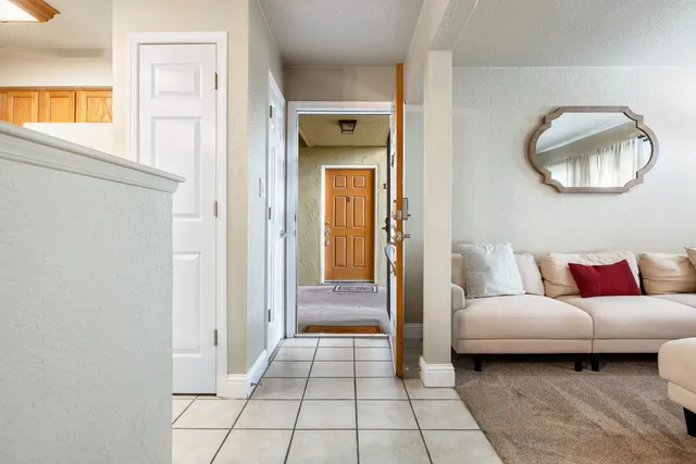 a living room with a mirror and a glass door shower