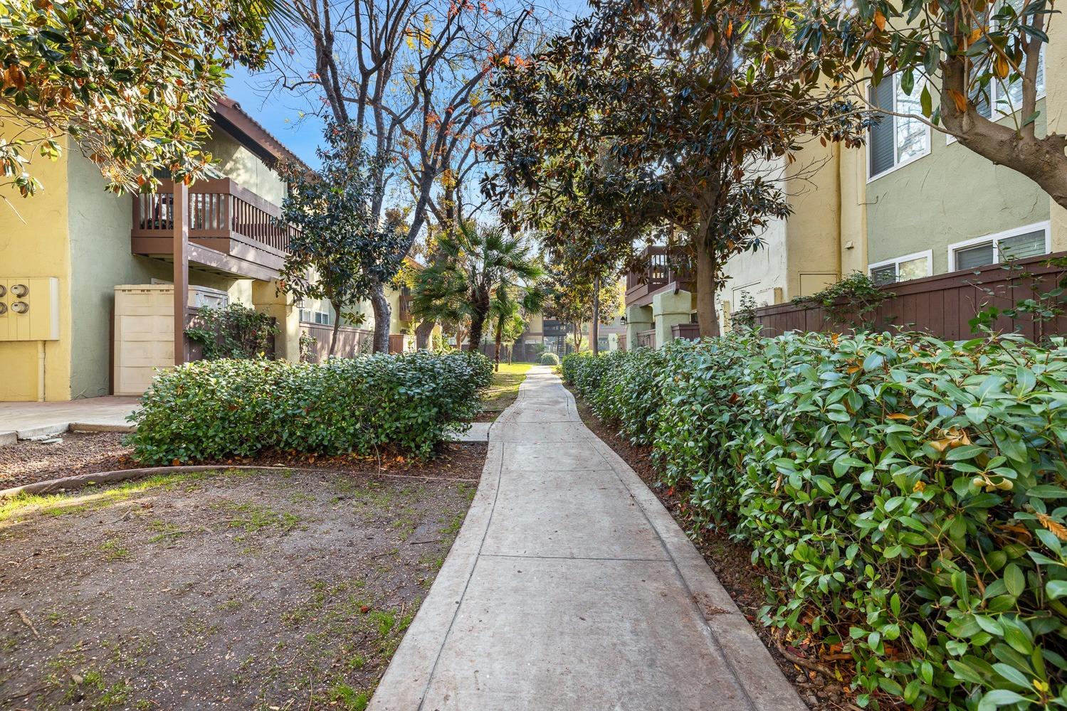 2881 Huntington Boulevard, Unit 137 Fresno, CA 93721 - Photo 23 of 29 a view of a pathway with a wrought fence