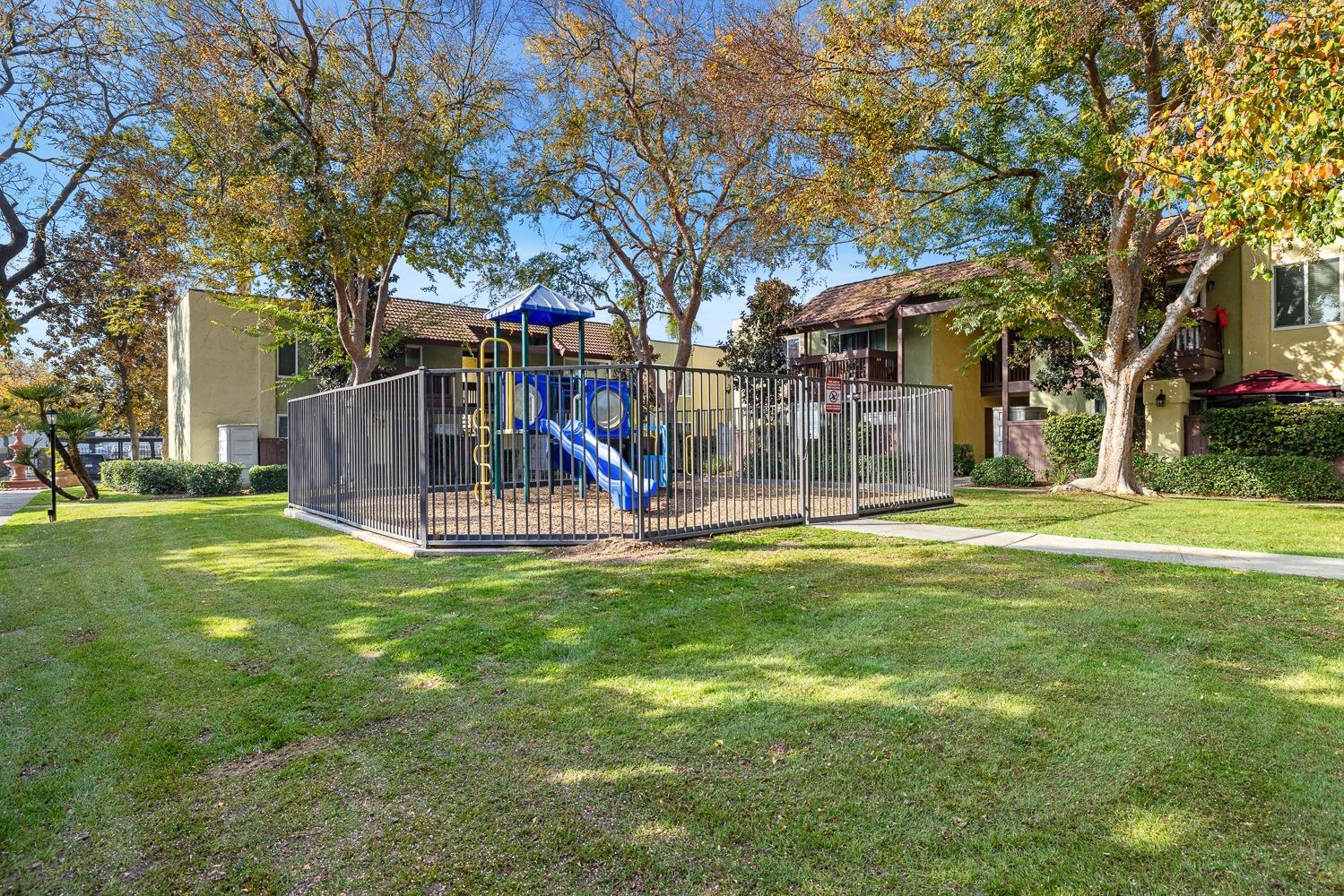2881 Huntington Boulevard, Unit 137 Fresno, CA 93721 - Photo 24 of 29 a view of a park with a slide