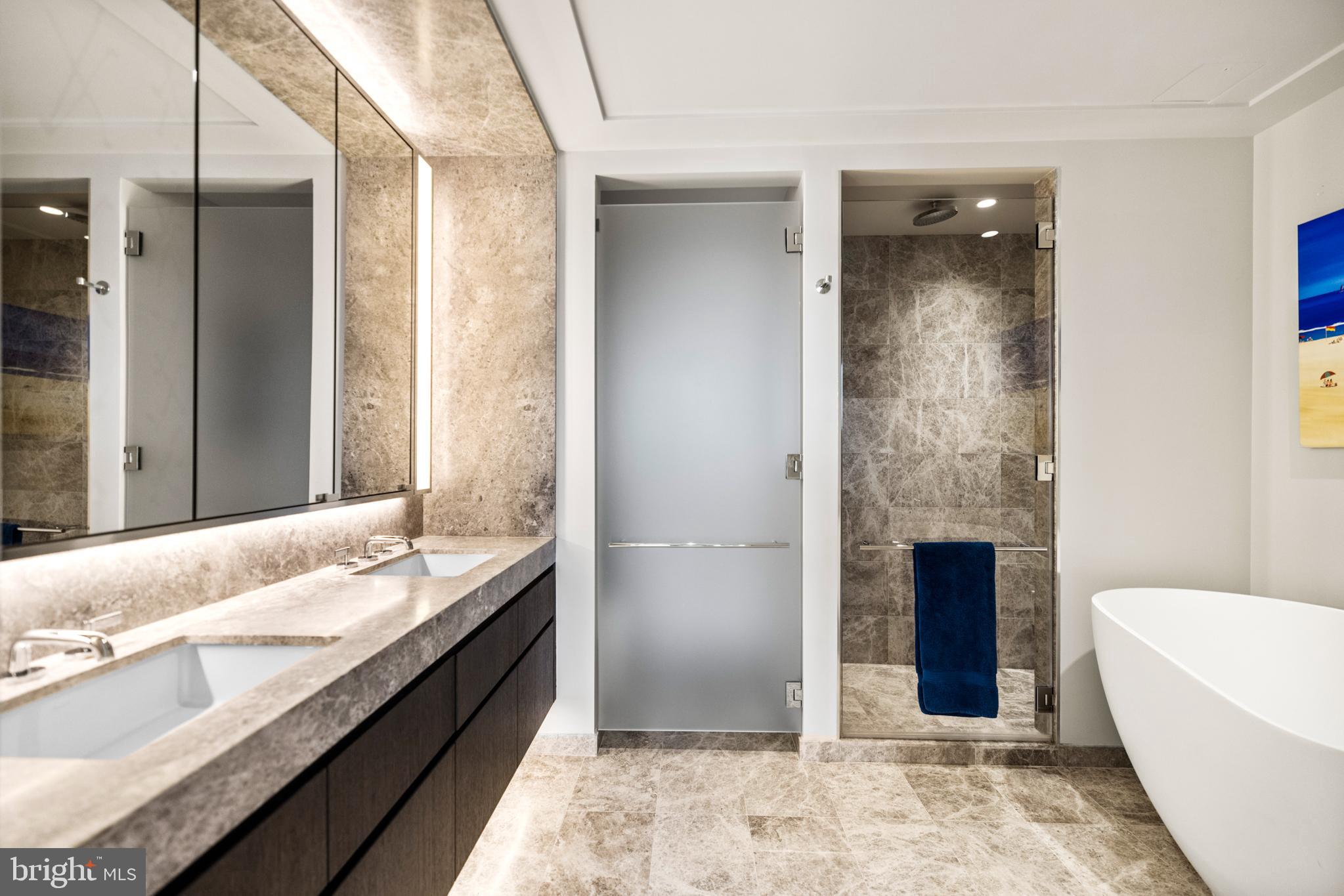 601 Wharf Street Southwest, Unit 602 Washington, DC 20024 - Photo 35 of 104 a spacious bathroom with a granite countertop tub sink and mirror