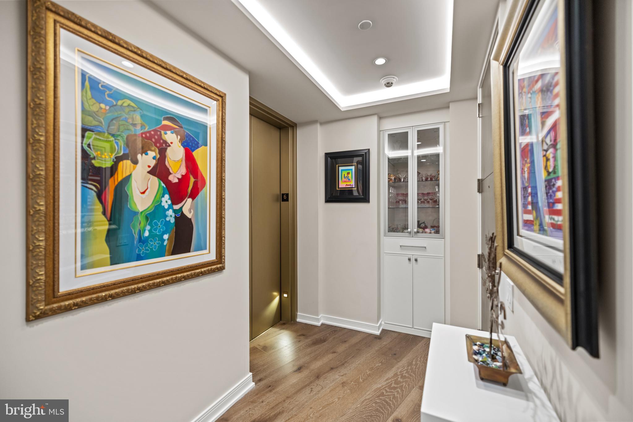 601 Wharf Street Southwest, Unit 602 Washington, DC 20024 - Photo 7 of 104 a view of a hallway with wooden floor and a workspace