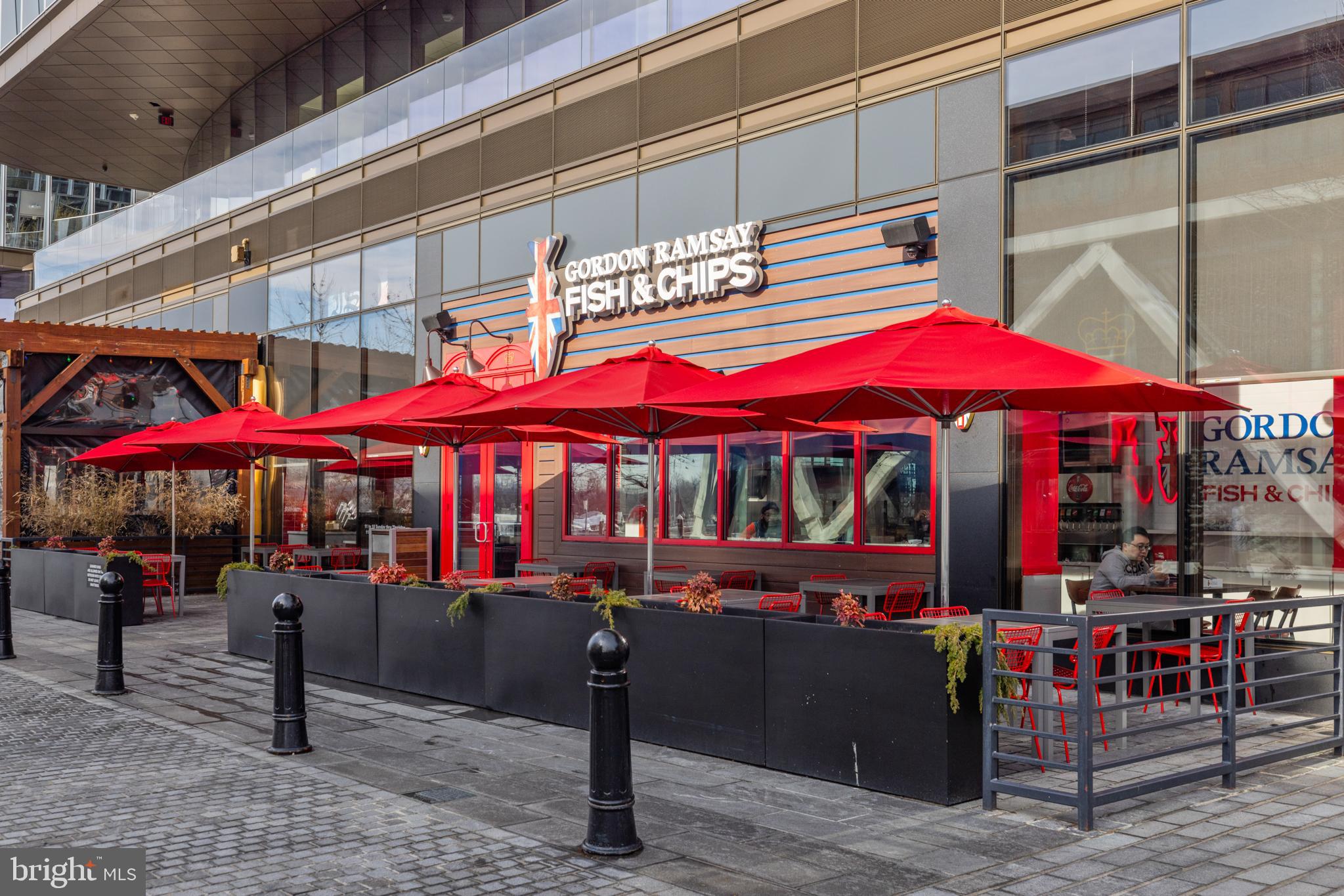 601 Wharf Street Southwest, Unit 602 Washington, DC 20024 - Photo 77 of 104 a view of a cafe with a table and chairs under an umbrella