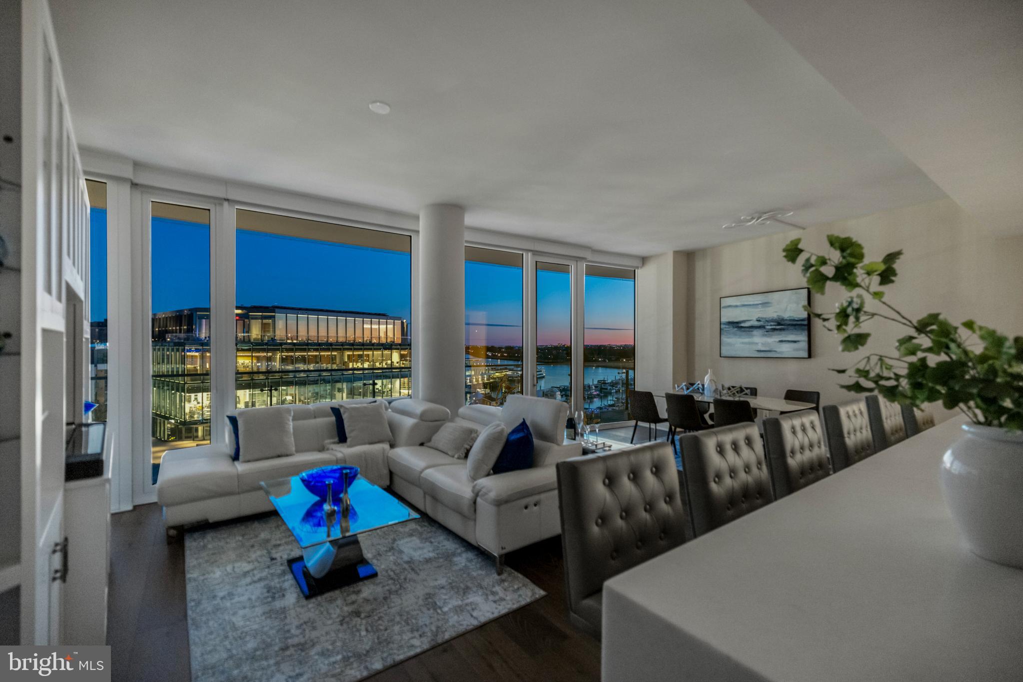 601 Wharf Street Southwest, Unit 602 Washington, DC 20024 - Photo 90 of 104 a living room with furniture and floor to ceiling windows